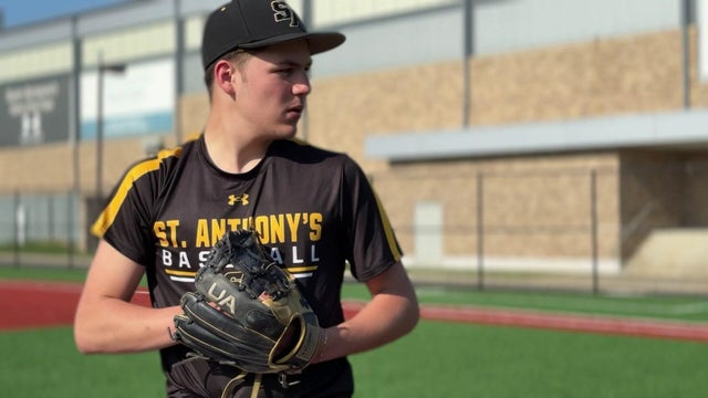 Anthony Pagliuca prepares to pitch on a baseball field. 