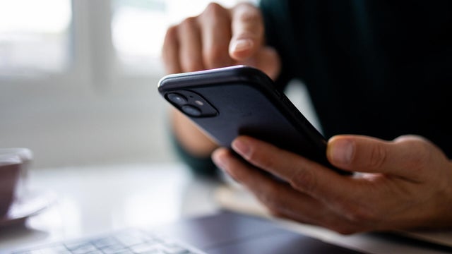 Close up on human hand using mobile phone 
