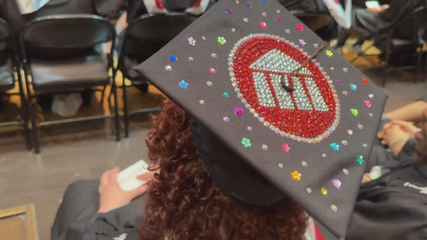 A graduation cap with a rhinestone rendition of the UArts logo 