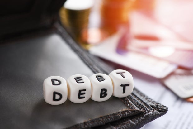 Debt credit card and money coin stack Increased liabilities from exemption debt consolidation,Romania
