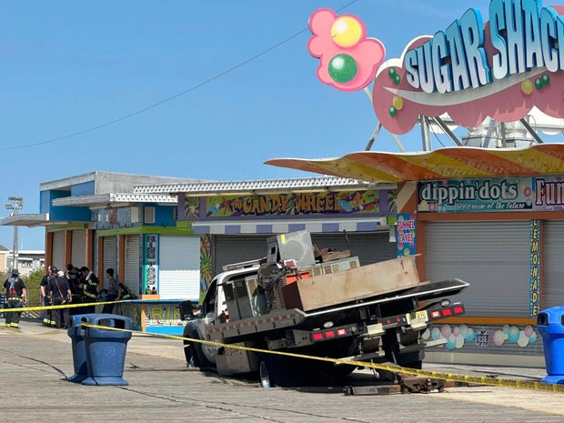 A truck partially fallen through the Wildwood boardwalk 