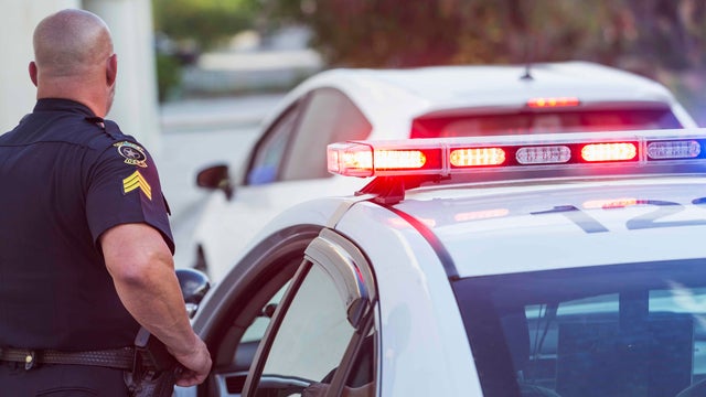 Police officer getting out of cruiser 