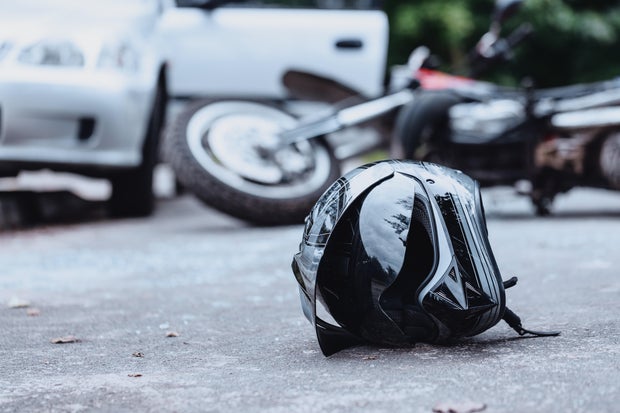 Black biker helmet on street 