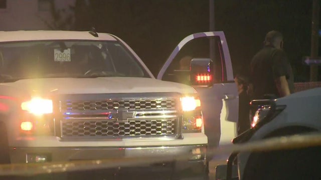 Police Car Stopped on a Road at Night with Emergency Lights 