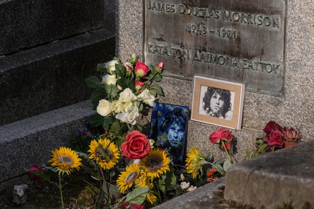Flowers and photographs lie at the grave of singer Jim Morrison at Pere Lachaise cemetery