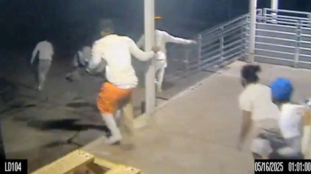 An image capture taken from handout video footage shows escaped inmates running through the loading dock at the Orleans Parish Justice Center, in New Orleans, Louisiana, May 16, 2025.