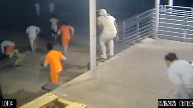 An image capture taken from handout video footage shows escaped inmates running through the loading dock at the Orleans Parish Justice Center, in New Orleans, Louisiana, May 16, 2025. 