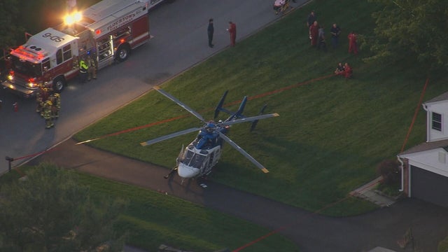 A small helicopter is seen on the driveway of a home 