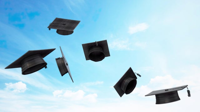 Six Graduation Caps Soaring Against a Blue Sky 