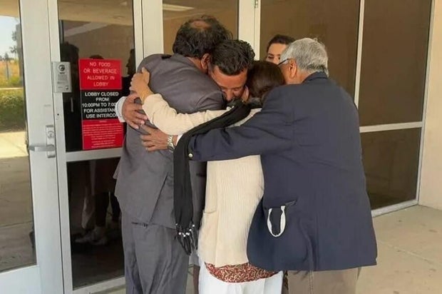 ajay-hugging-family.jpg 