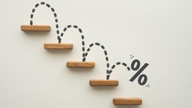 Percent sign moving down from top stair on white background. 