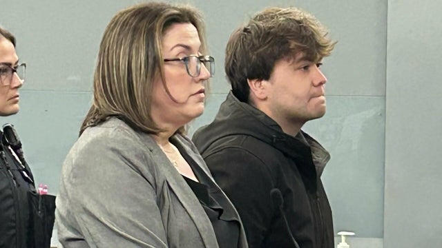 Kyle Vazquez stands with a lawyer in court. 