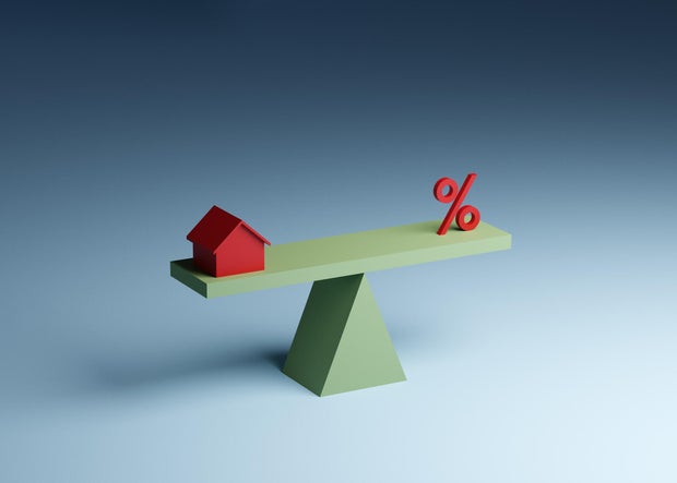 House and percentage sign on seesaw 