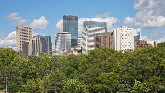 Skyline with downtown office skyscrapers above trees of Loring Park, Minneapolis, Minnesota, Midwest, USA 