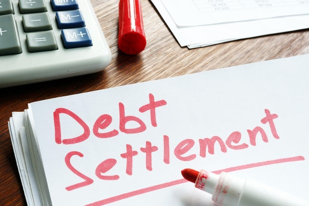 Debt Settlement handwritten on loan documents. 