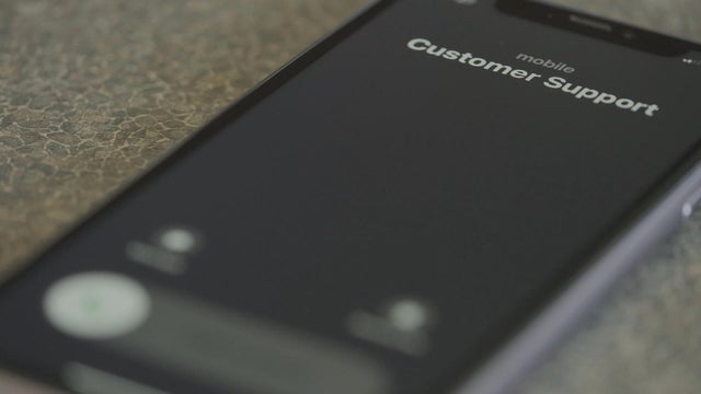 A iPhone shows an incoming call from Customer Support 