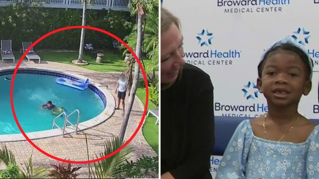 Two lifeguards giving cardiopulmonary resuscitation (CPR) to a drowned man 