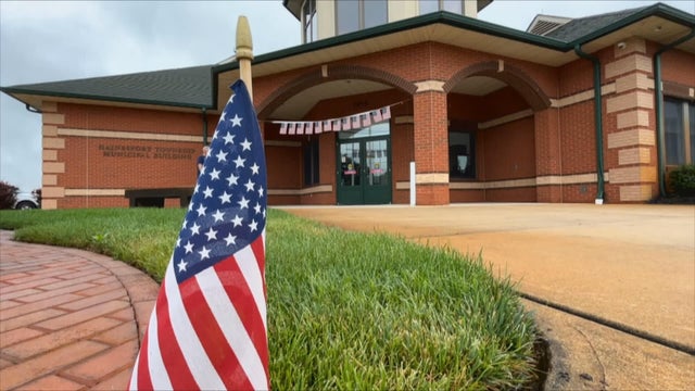A small American flag is planted in the ground in front of a polling place in Hainesport, New Jersey, for the 2025 primary 