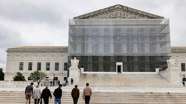 Pedestrians walk in front of the Supreme Court building in Washington, D.C., on Wednesday, May 21, 2025. 