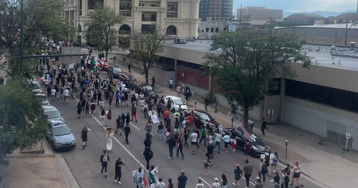 Rallyers demonstrating against ICE arrests march down the middle of Lincoln 