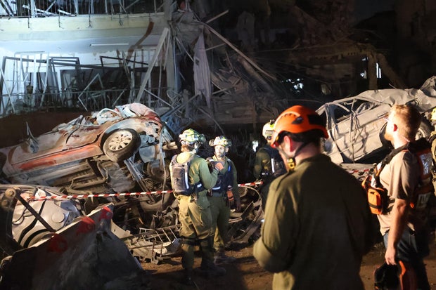 Israeli army evacuate people from destroyed buildings in Tel Aviv following Iranian missile strikes