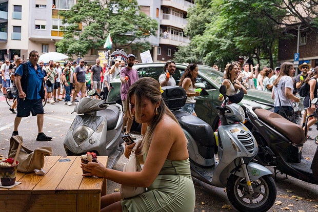 People spray tourists and buildings with water guns and