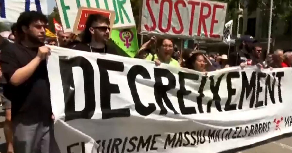 Demonstrators in Spain protest against mass tourism, spraying tourists with water guns
