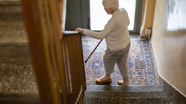 Elderly woman walking down the stairs 