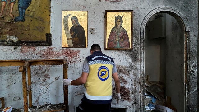 A member of the Syrian security force inspects the damage after a blast rocked the Mar Elias Church in the Dweila neighbourhood of Damascus 