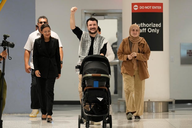Mahmoud Khalil, center, reacts alongside his wife, Noor Abdalla, right, upon arriving at Newark International Airport , Saturday, June 21, 2025, in Newark, N.J. 