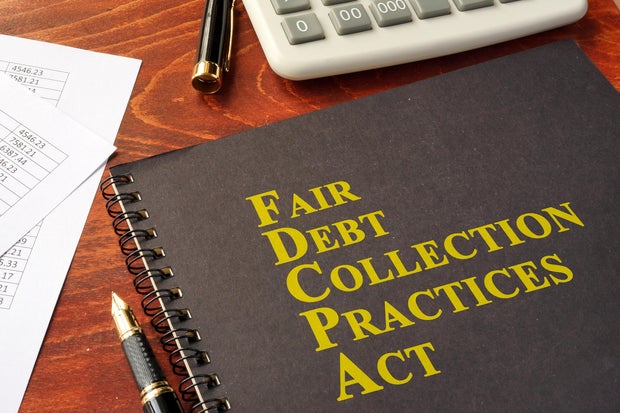 FDCPA Fair Debt Collection Practices Act on a table. 