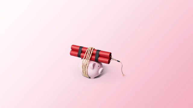 Piggy bank tied to a bundle of dynamite sticks 