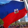 A speaker addresses the crowd during a Haitian Flag Raising Ceremony in Boston on May 17, 2024. 