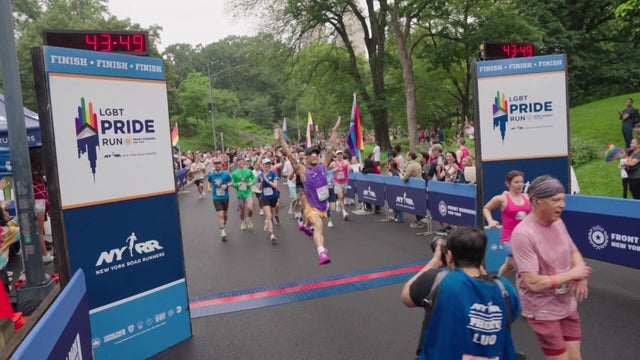 Runners cross the finish line of the NYRR Pride Run. 