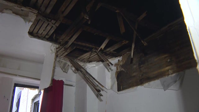 A section of the ceiling and wall gutted by fire. 