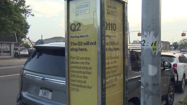 A sign showing the Q2 and Q110 bus lines will no longer stop at that bus stop. 