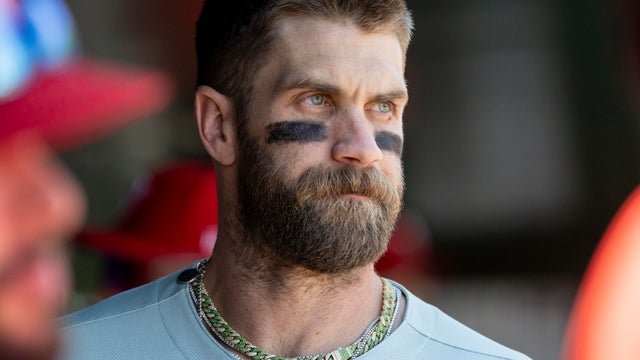 A close up photo of Bryce Harper in the dugout 