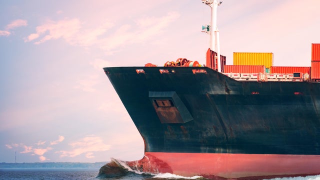 Cargo freighter ship with intermodal shipping containers at sea 