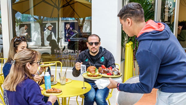 Miami, Florida, Design District OTL restaurant al fresco dining waiter serving food 