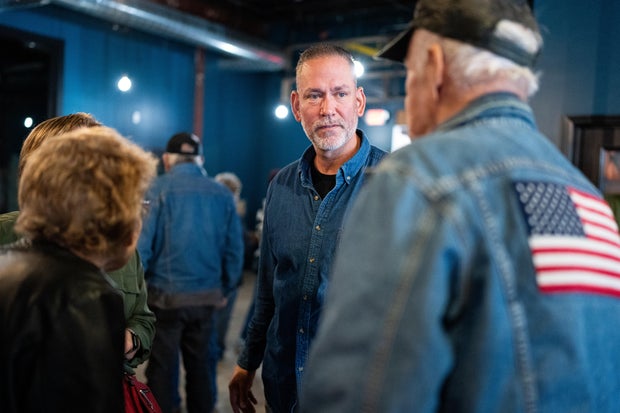 Independent Senate candidate Dan Osborn chats with attendees after speaking during his campaign stop at the Handlebend coffeshop in O'Neill, Neb., on October 14, 2024. 