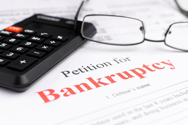 Bankruptcy concept. Close-up bankruptcy petition with calculator and glasses. 