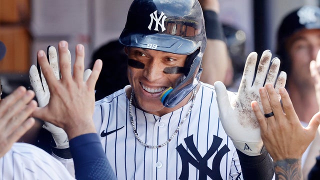 Aaron Judge #99 of the New York Yankees celebrates in the dugout after his ninth inning two run home run against the Chicago Cubs at Yankee Stadium on July 12, 2025 in New York City. 