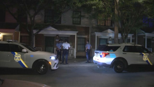 Two Philadelphia police cars on a residential street in North Philadelphia 