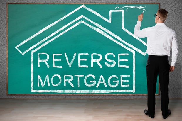 Businessman Drawing House With Reverse Mortgage Text 