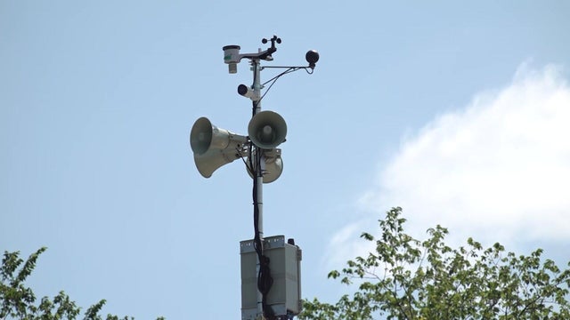 A speaker on a pole in a Paterson park 
