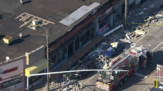 A collapsed facade outside a store in Queens 