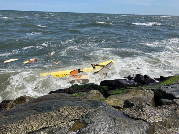 A damaged boat is seen in the water near a jetty in Avalon 