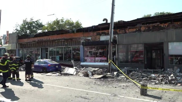 A collapsed facade outside a store in Queens 