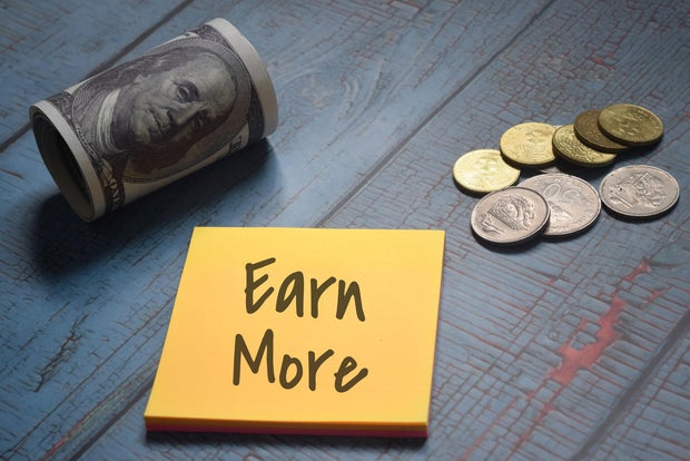Earn More wording with money and coins. Financial concept 