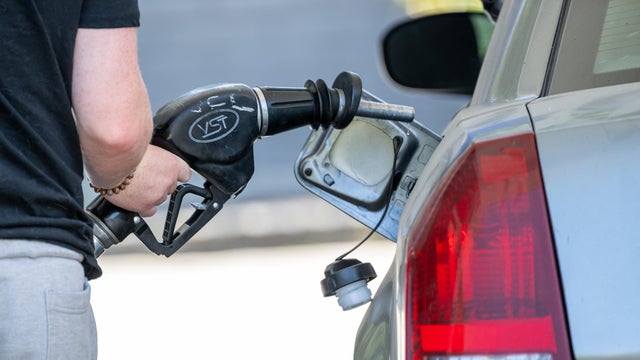 Driver filling up at a gas station 